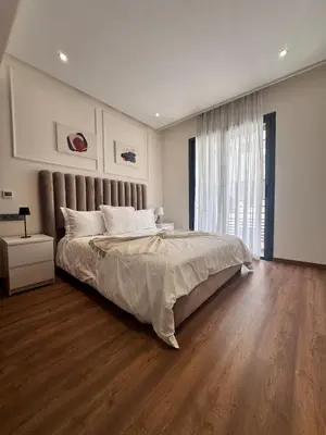 a bedroom with a large bed and a large window at Central Maarif Studio in Casablanca