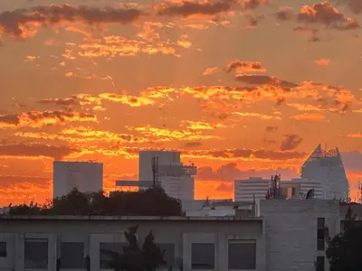 a city skyline with a sunset in the background at Chic & central in Maarif