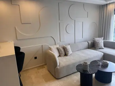 a living room with a couch and two tables at Chic & central in Maarif