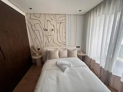 a bedroom with a bed and a wall with a tree mural at Comfortable & Central Casablanca Apartment in Casablanca