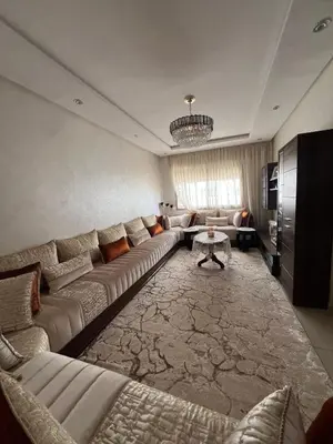 a living room with a couch and a table at Les jardins d'Atlantis Dar Bouazza in Tamaris