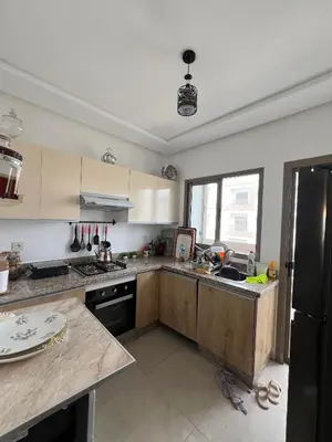 a kitchen with a sink and a refrigerator at Les jardins d'Atlantis Dar Bouazza in Tamaris