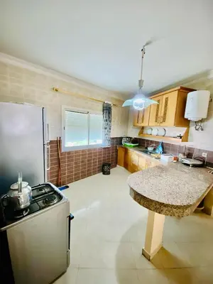 a kitchen with a stove and a counter top at logement entier familly house in Tamaris