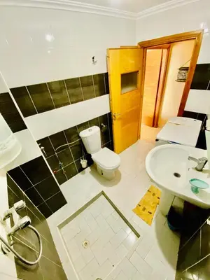 a bathroom with a toilet and a sink at logement entier familly house in Tamaris