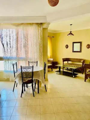 a dining room with a table and a piano at logement entier familly house in Tamaris