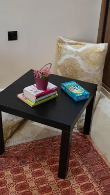 a black table with books and a potted plant on it at Nafhat al arz - Moroccan and refined in Mohammedia