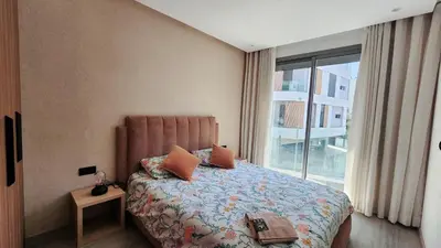 a bedroom with a bed with a large window at Studio Cosy les Princesses in Casablanca