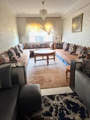 a living room with a couch and a table at résidence Amina in Rabat