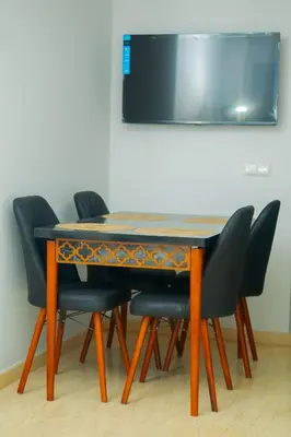a dining room table with four chairs around it at Living Like Home in Casablanca