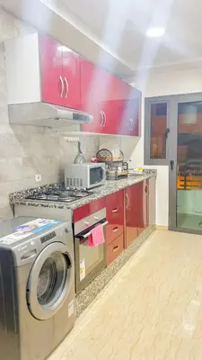 a kitchen with a stove and a washing machine at Living Like Home in Casablanca