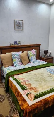 a bedroom with a large bed with pillows on it at appartement el Mansouria Sable d'or in O Ben Slimane
