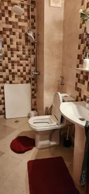 a bathroom with a toilet and a sink at appartement el Mansouria Sable d'or in O Ben Slimane