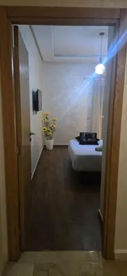 a room with a bed and a blue light at Appartement Flora Nora in Casablanca