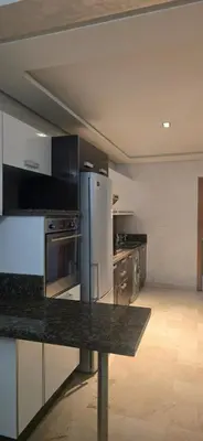 a kitchen with stainless steel appliances in a room at Appartement Flora Nora in Casablanca