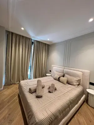 a bedroom with a large bed with two pillows on it at Appartement Le Claridge in Casablanca