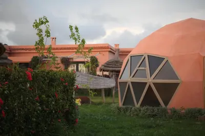an orange dome in the yard of a house at Bougainvilla Guesthouse in Sidi Moussa Ben Ali