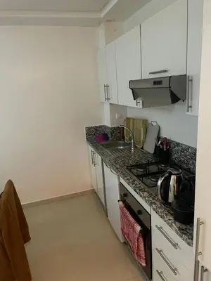 a kitchen with a sink and a stove top oven at Ola blanca 1 enjoy in Sidi Rahal