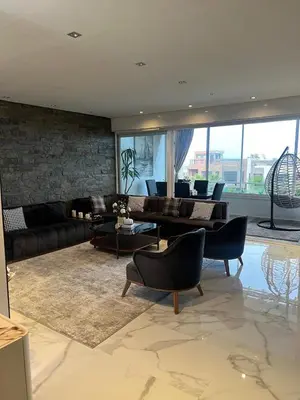 a living room with a couch and a table and chairs at Appartament Melrose beach dar bouazza in Tamaris