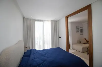 a bedroom with a blue bed and a mirror at Comfort & Premium in Casablanca