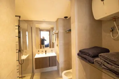 a bathroom with a sink and a toilet and a mirror at Appartement Ferme Bretonne - Confort & Premium in Casablanca