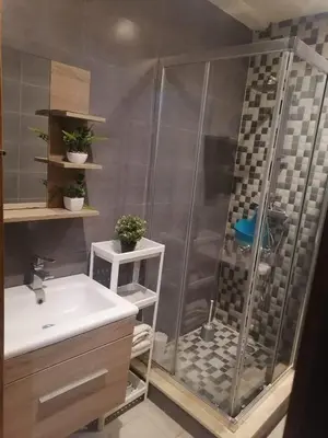 a bathroom with a shower and a sink at Apparemment haut standing Mansbay in Mohammedia