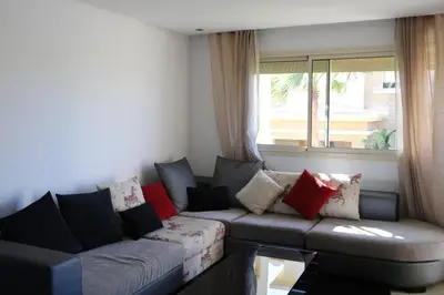 a living room with a couch and a window at Cozy beach house in Skhirat