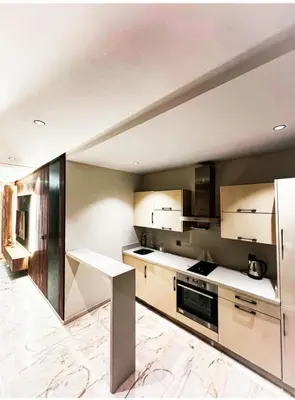 a kitchen with stainless steel appliances and a table at Studio luxueux in Casablanca
