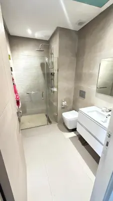 a bathroom with a shower and a toilet and a sink at luxury apartement en el mansouria in Pont Blondin