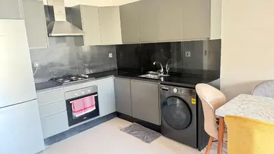 a kitchen with a washer and a washing machine at luxury apartement en el mansouria in Pont Blondin