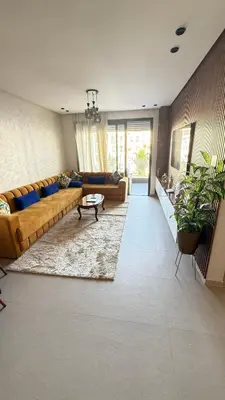 a living room with a couch and a table at luxury apartement en el mansouria in Pont Blondin