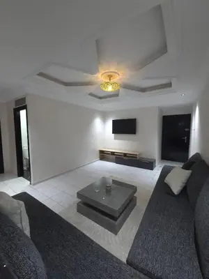 a living room with a couch and a flat screen tv at Havre de paix en plein coeur de Casa in Casablanca