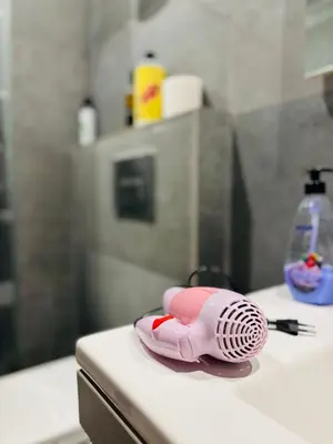 a pink hairdryer sitting on top of a counter at Studio cosy in Casablanca