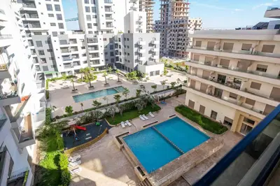 an overhead view of a pool in a city with buildings at Charmante Deux Chambres et Salon Avec Jardin et Piscine à coté de plage in Casablanca