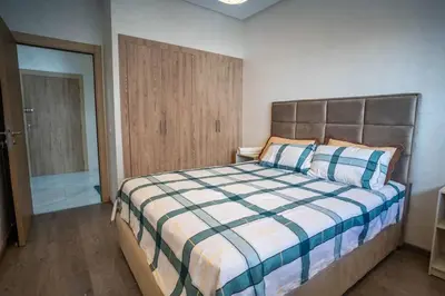 a bedroom with a bed with a checkered blanket at Charming Studio for Rent with Pool Access & Kids Playground in Casablanca