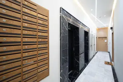 a hallway with wooden lockers in a room at Appartement 2 Chambres à Coté avec Grand Balcon, Piscine, Aire de Jeux pour Enfants et Jardin in Casablanca