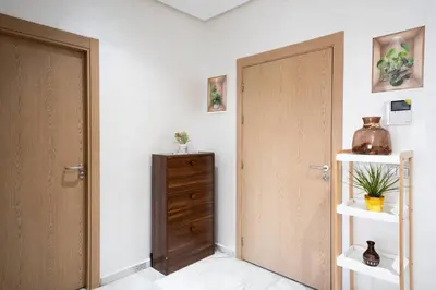 a room with a door and a wooden cabinet at Studio Confortable avec Balcon, Piscine, Jardin et Aire de Jeux in Casablanca