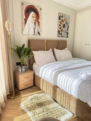 a bedroom with a bed and a picture of a nun at HBkf Residence in Casablanca