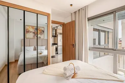 a bedroom with a bed and a large mirror at VIVASTAY Casablanca - Cosy Maarif Arena 41 in Maarif