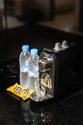 a toaster and two bottles of water on a counter at Cosy Studio - Fitness access & Free Parking & Wifi Fiber in Casablanca