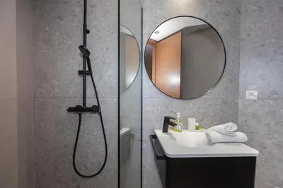 a bathroom with a shower and a sink and a mirror at Cosy Studio - Fitness access & Free Parking & Wifi Fiber in Casablanca