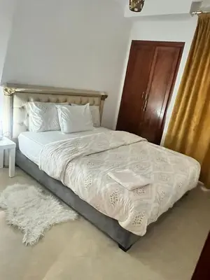 a bed with white sheets and pillows in a bedroom at La Parenthèse de CASABLANCA in Casablanca