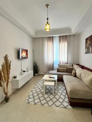 a living room with a couch and a table at La Parenthèse de CASABLANCA in Casablanca