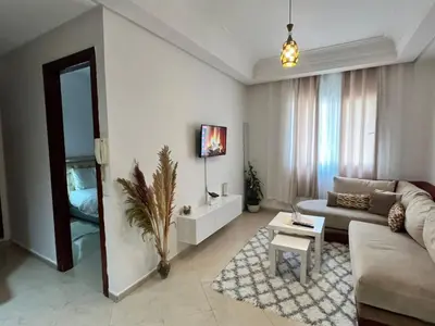 a living room with a couch and a table at La Parenthèse de CASABLANCA in Casablanca