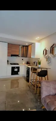 a kitchen with a table and chairs in a room at LA Princesse 12th in Casablanca