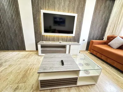 a living room with a couch and a tv at Comfortable, quiet and beach apartment in Skhirat