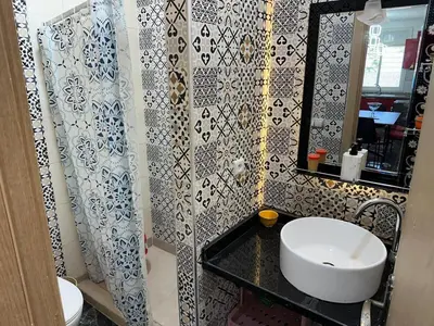 a bathroom with a white sink and a mirror at Apartment 1 CH près de la plage in Oulad Akkou