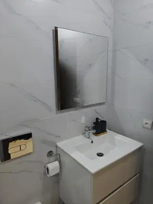 a white bathroom with a sink and a mirror at Casa Atlantica mit Meerblick und Poolparadies in Mansouria