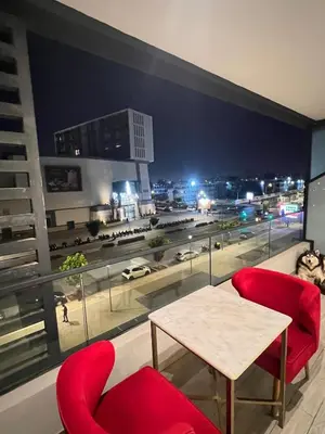 a room with a table and chairs and a view of a city at Casablanca Finance City 33 Tower in Casablanca
