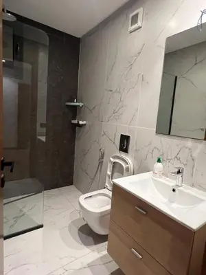 a bathroom with a toilet and a sink and a mirror at Casablanca Finance City 33 Tower in Casablanca