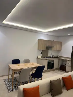 a living room with a table and a couch at Casablanca Finance City 33 Tower in Casablanca